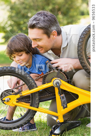 Father and son fixing bike Father and son fixing bike 9656533
