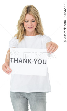Smiling female volunteer holding 'thank you' paper Smiling female volunteer holding 'thank you' paper 9656536