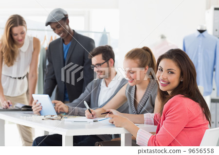 Fashion designers discussing designs Fashion designers discussing designs 9656558