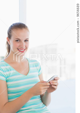 Portrait of a beautiful young woman text massaging 9656689