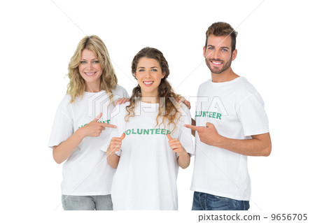 Portrait of happy volunteers pointing to friend 9656705