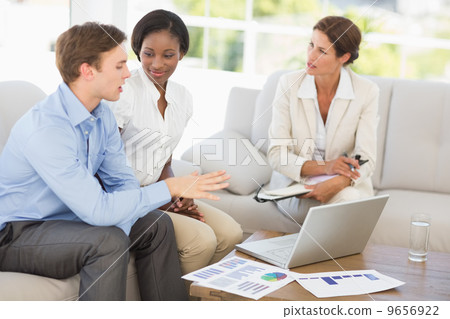 Business team meeting to go over numbers on the couch Business team meeting to go over numbers on the couch 9656922
