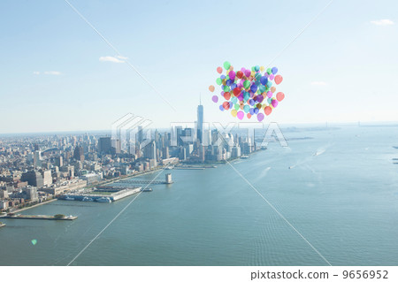 Many colourful balloons above coast 9656952