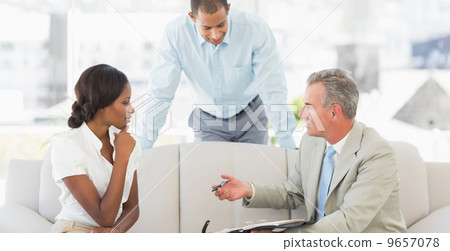 Salesman showing clients where to sign the deal Salesman showing clients where to sign the deal 9657078