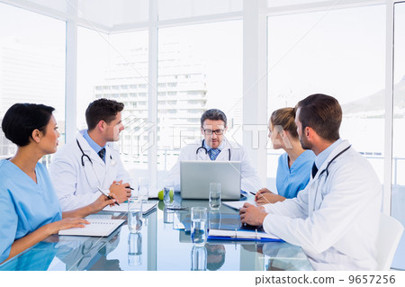 Concentrated medical team around desk 9657256