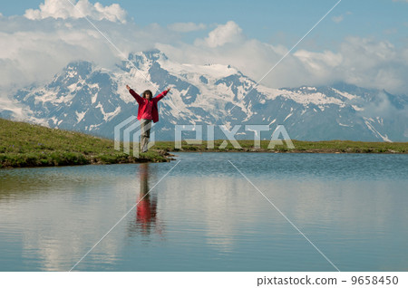 People near mountain lake - Mestia, Georgia 9658450