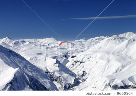 Sky gliding in snowy mountains 9660564