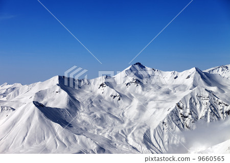 Snowy mountains and blue sky 9660565