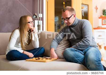 Father and daughter playing checkers Father and daughter playing checkers 9660744