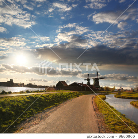 Traditional Dutch windmills with canal in Zaanse Schans near the Amsterdam, Holland 9660900