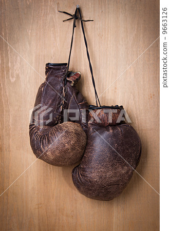 old boxing gloves hang on nail on wall old boxing gloves hang on nail on wall 9663126