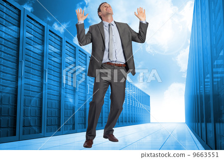 Composite image of businessman posing with arms raised 9663551