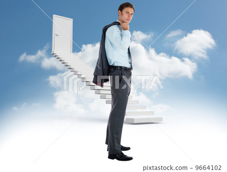 Composite image of serious businessman holding his jacket Composite image of serious businessman holding his jacket 9664102