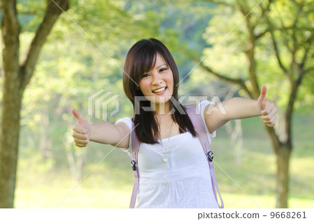 Mixed race thumb up college girl standing at campus 9668261