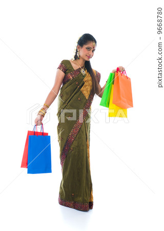traditional South Indian woman holding Deepavali shopping bags a 9668780