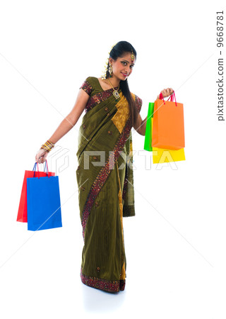 Portrait of a woman in traditional saree holding gifts and smili 9668781