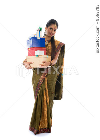 Portrait of a woman in traditional saree holding gifts and smili 9668785