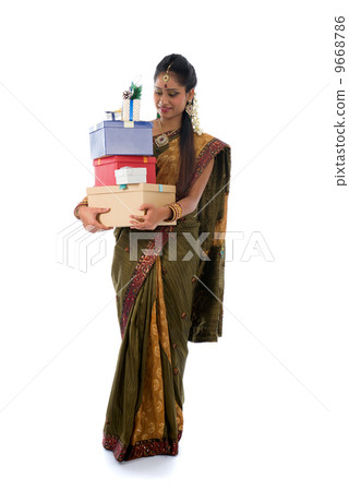 Portrait of a woman in traditional saree holding gifts and smili Portrait of a woman in traditional saree holding gifts and smili 9668786