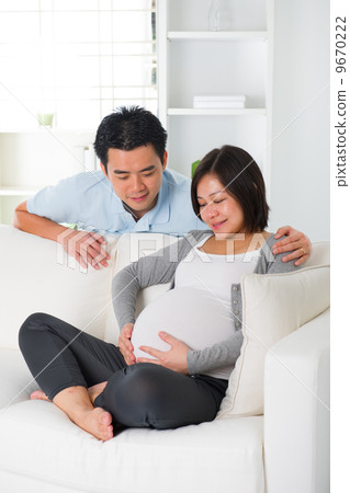 asian chinese pregnant couple lifestyle photo with living room a asian chinese pregnant couple lifestyle photo with living room a 9670222
