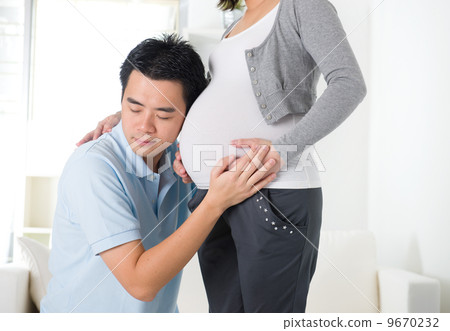 chinese husband listening to his wife's stomach chinese husband listening to his wife's stomach 9670232