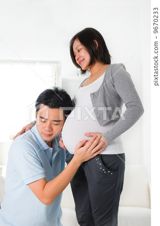 chinese husband listening to his wife's stomach chinese husband listening to his wife's stomach 9670233