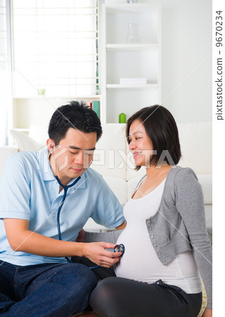asian chinese pregnant couple lifestyle photo with living room a asian chinese pregnant couple lifestyle photo with living room a 9670234