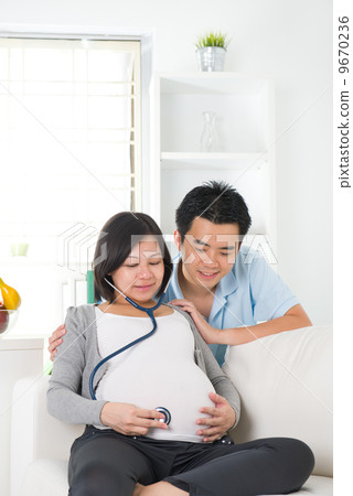 asian chinese pregnant couple lifestyle photo with living room a asian chinese pregnant couple lifestyle photo with living room a 9670236