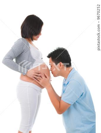 chinese Man Listening To Pregnant Woman's Stomach chinese Man Listening To Pregnant Woman's Stomach 9670252