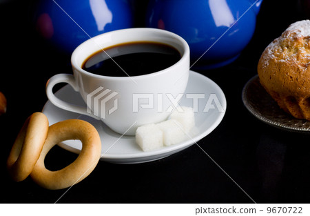 Coffee with pastry on black background 9670722