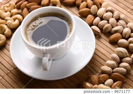 White cup of coffee with lot of nuts White cup of coffee with lot of nuts 9671177