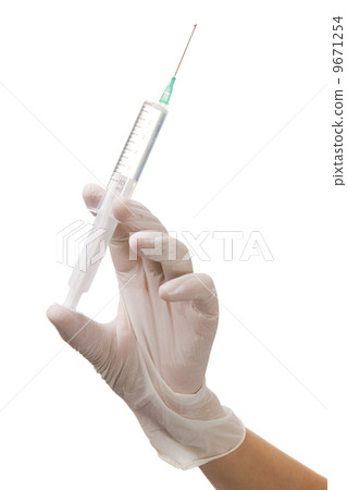 Nurse's hand holding a syringe 9671254