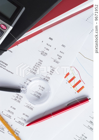 Worktable covered with financial documents 9671952