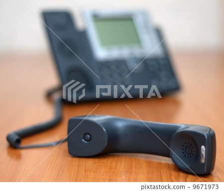 Telephone receiver with phone on background 9671973