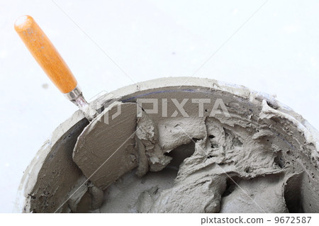 dirty trowel and bucket on building site dirty trowel and bucket on building site 9672587