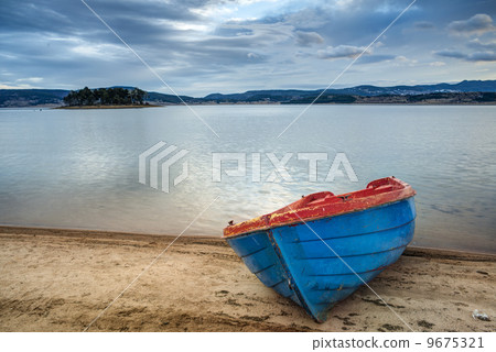 Boat on a lake in the mountains Boat on a lake in the mountains 9675321