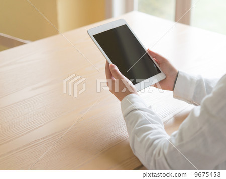 A woman with a tablet A woman with a tablet 9675458