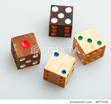 four wooden gambling dices on white table four wooden gambling dices on white table 9675492