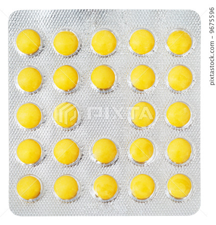 yellow pills in blister pack isolated 9675596