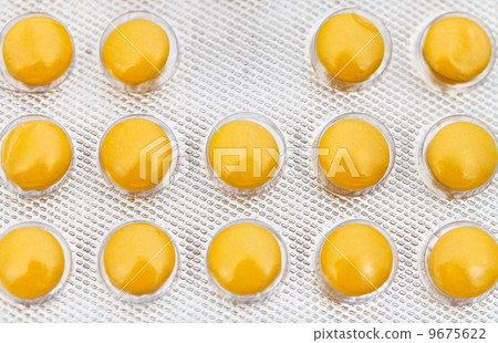 yellow tablets in blister pack close up 9675622