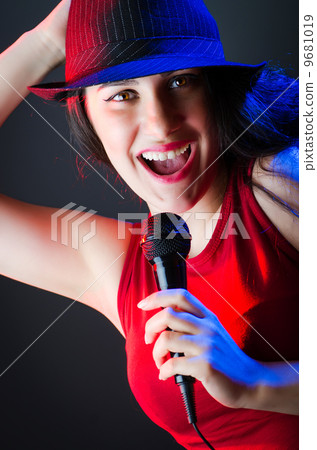 Female performer at disco with mic Female performer at disco with mic 9681019