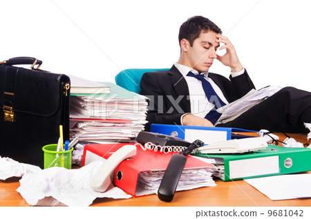 Young busy businessman at his desk 9681042