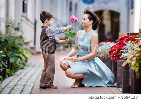 Little boy giving flower to his mom 9684127