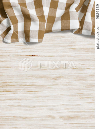 folded tablecloth over bleached wooden table 9684189