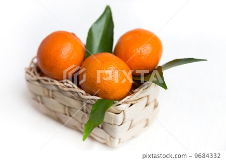 fresh orange mandarins with leafs in basket 9684332