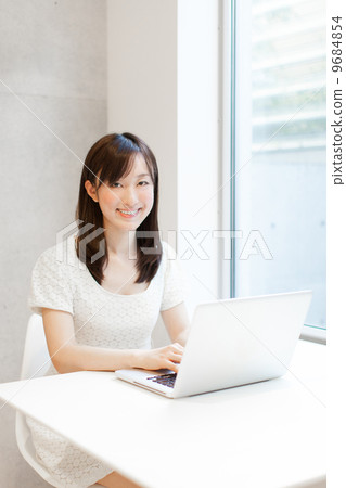 A woman using a computer A woman using a computer 9684854