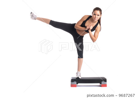 Young slender brunette exercising on stepper 9687267