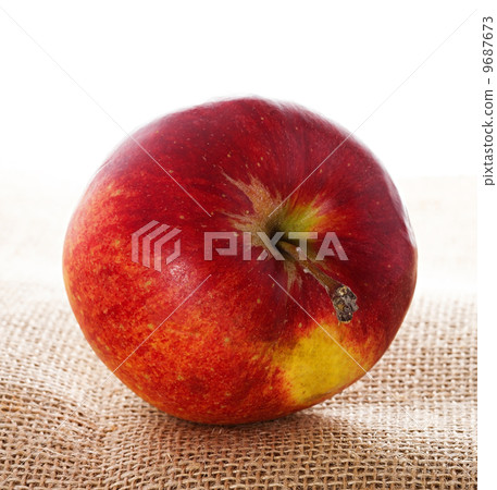 Ripe red apple on burlap 9687673