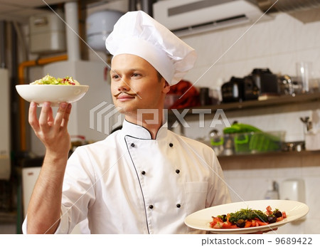 Young chief cook with gourmet food on kitchen in restaurant 9689422