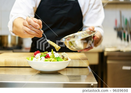 Chief cook preparing salad Chief cook preparing salad 9689698