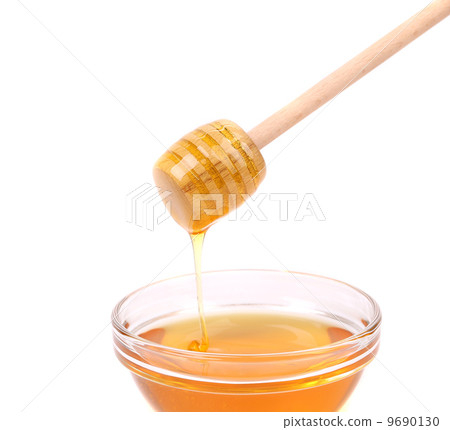 Bee honey with wooden dipper. 9690130